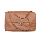 Brown leather handbag with Chanel logo on a white background