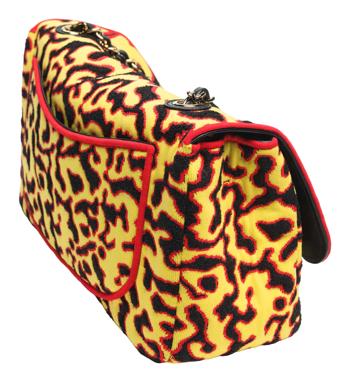 Yellow and black patterned handbag with red accents on a white background
