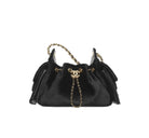 Black handbag with gold chain and Chanel logo on a white background
