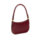 Maroon handbag with gold accents on a light beige background