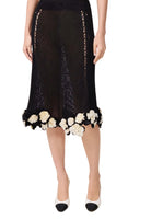 Black lace skirt with floral details on a white background