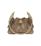 Beige quilted handbag with gold chain detail on a white background