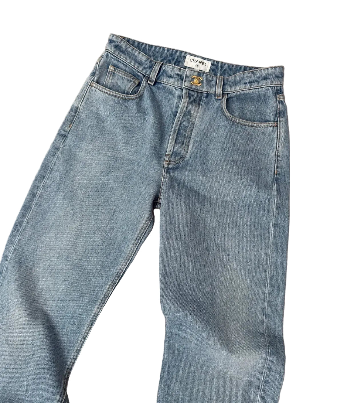 Pair of light blue jeans on a beige carpet