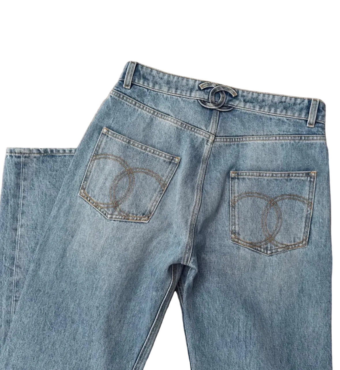 Pair of blue jeans with a brand logo on a beige carpet