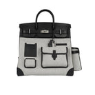 Black and gray handbag with visible brand logo on a white background
