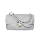 A light gray pebbled leather shoulder bag with a gold-tone interlocking CC logo clasp, photographed on a clean white background.