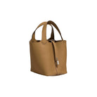 Tan handbag on a light gray background