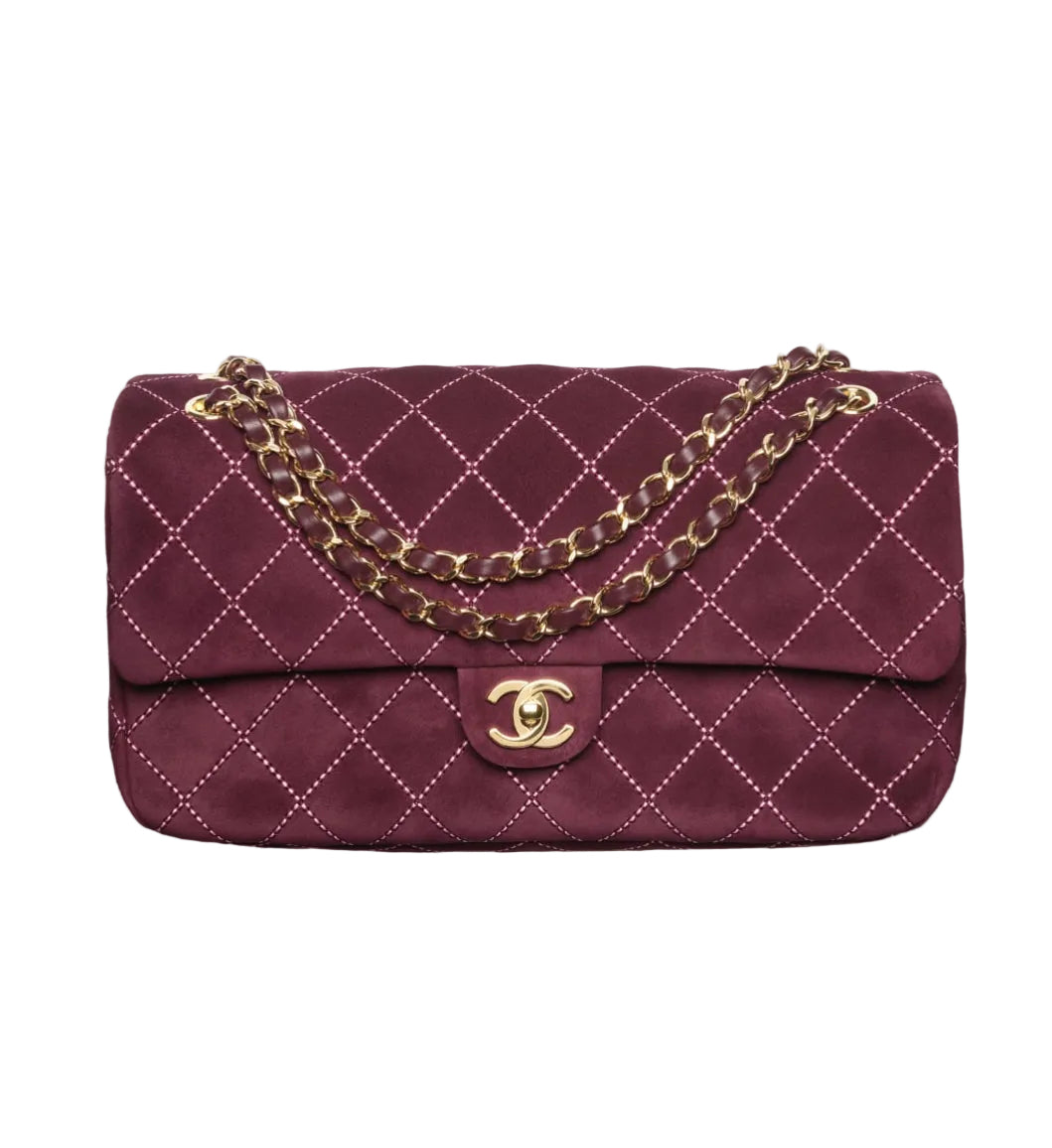 A vintage Chanel quilted flap bag in burgundy suede with gold-tone chain strap and a gold interlocking CC turn-lock closure, shown against a plain white background.