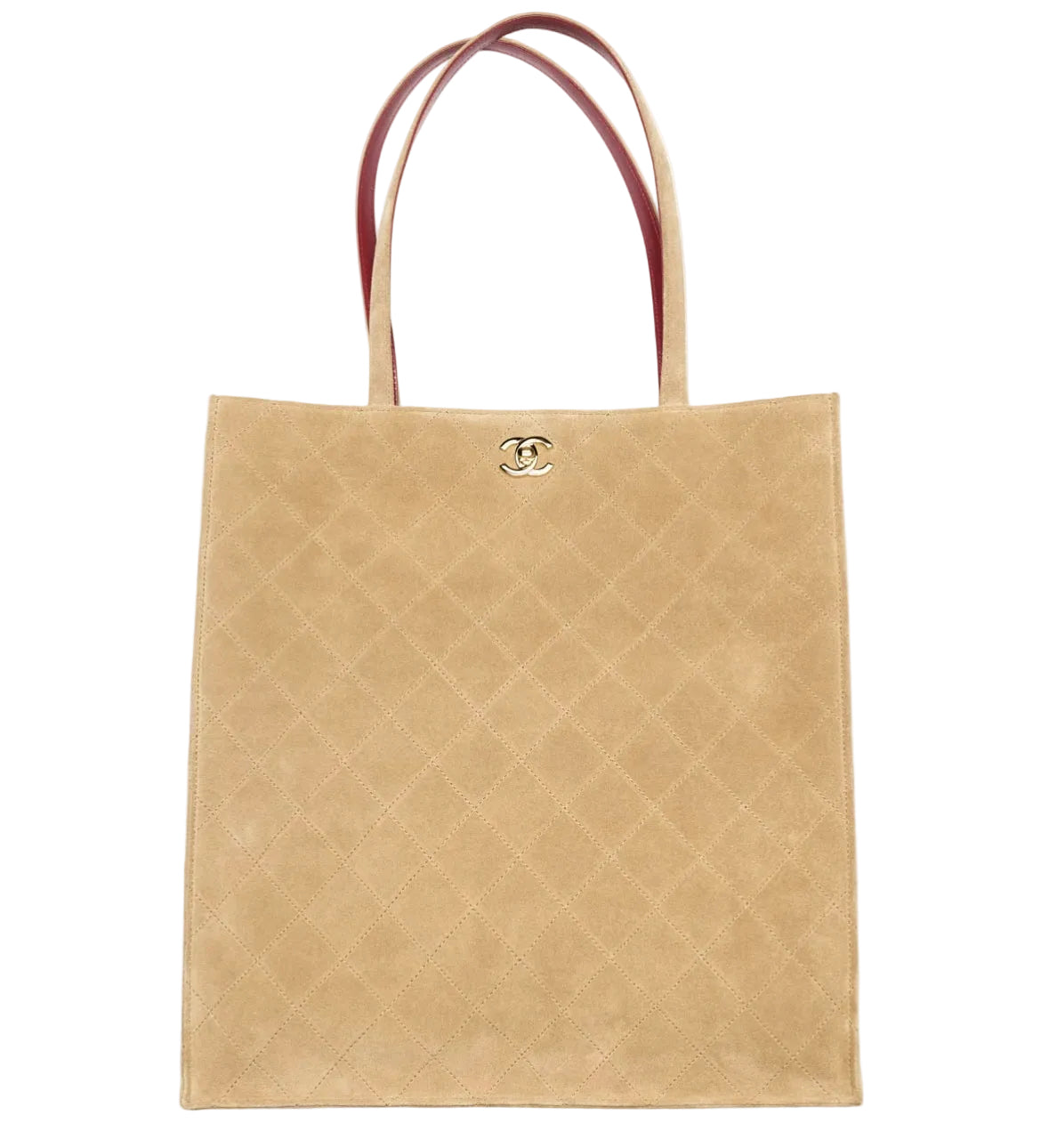 A beige quilted suede tote bag with dark reddish-brown leather handles and a gold-tone interlocking CC logo on the front, set against a plain white background.