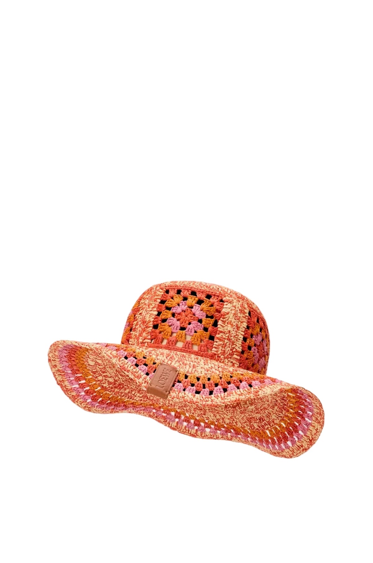 Orange woven hat with a decorative band on a light gray background