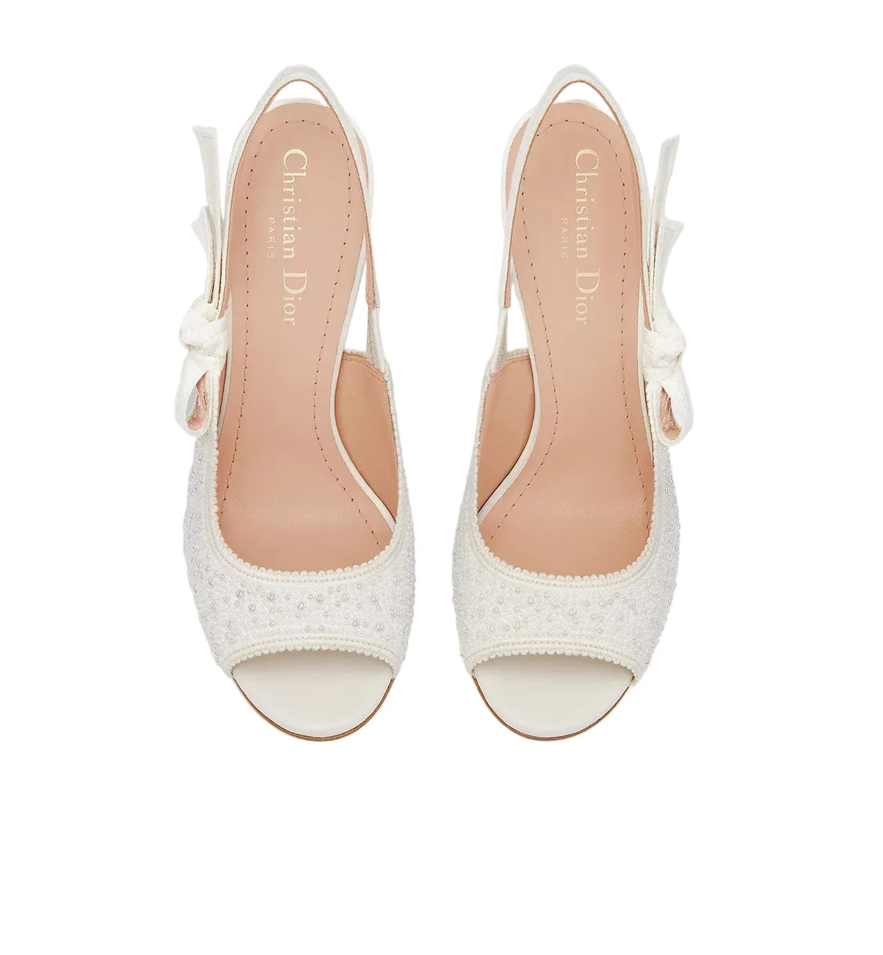 White high-heeled sandals with 'Christian Dior' branding on a light gray background