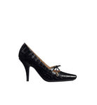 Black crocodile-patterned high-heeled shoe on a light gray background