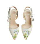 Floral high-heeled shoes with Dior branding on a light gray background