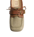 A Dior boat shoe featuring a beige suede upper, brown leather straps, and gold-tone hardware, shown from a top-down view on a light gray background.