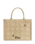 Beige textured handbag with 'Dior' logo on a light gray background