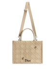 Beige Dior handbag with a strap on a light gray background