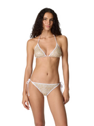 Woman wearing a white lace bikini set on a plain background