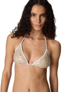 Woman wearing a white bikini with gold floral patterns against a plain background