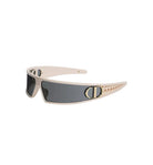 A pair of wraparound sunglasses with a light beige frame, dark gray lenses, and gold-tone hardware, displayed on a clean light gray background.