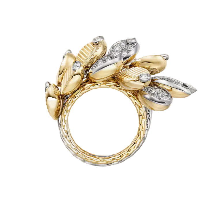 Gold and silver ring with floral design on a light gray background