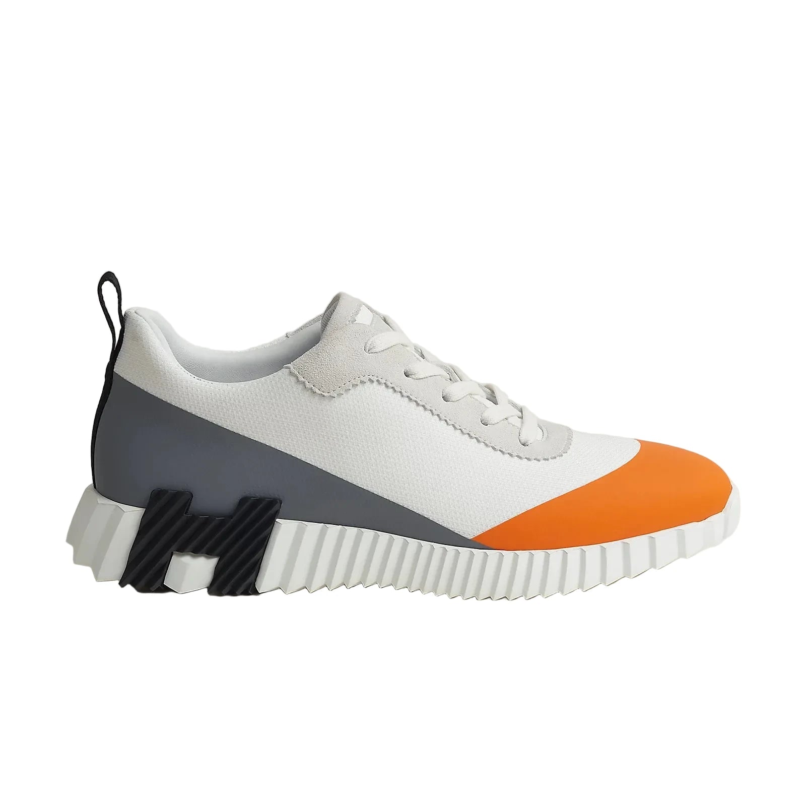 Sneaker with white, orange, and gray design on a light background