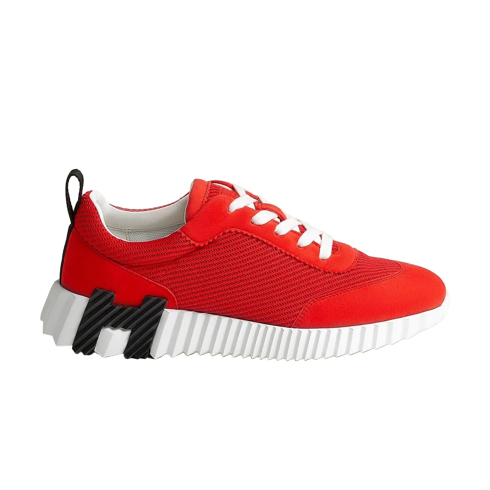 Red sneaker with white sole on a light gray background