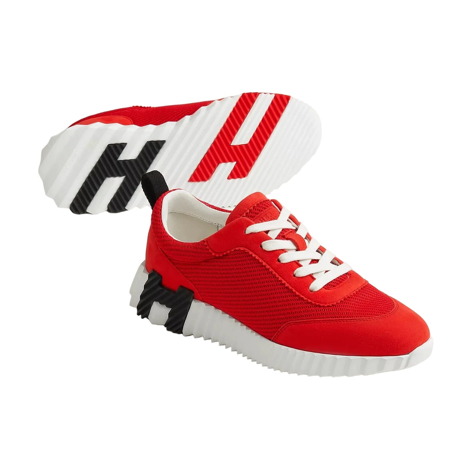 Red sneakers with black and white accents on a light gray background