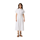 Woman wearing a white dress on a beige background