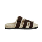Brown and white slide sandal on a light gray background