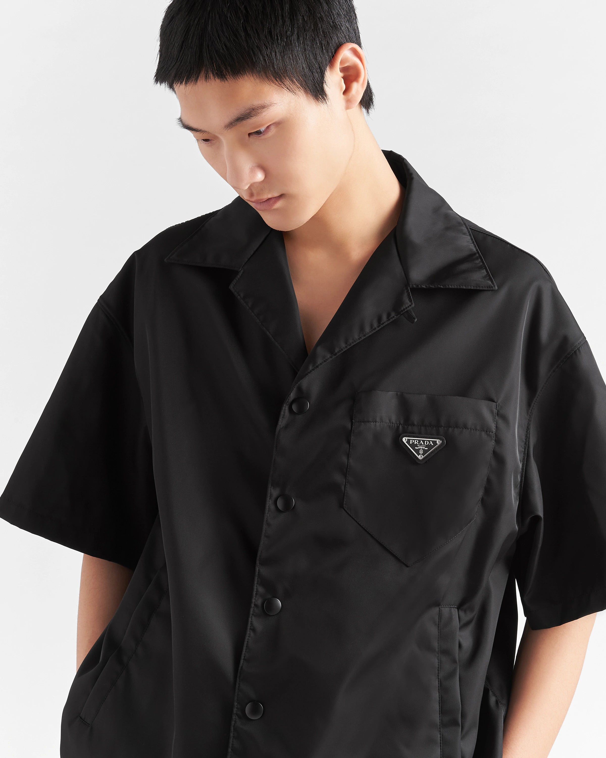 prada dress shirt Classic-fit cotton with embroidered logo in white MAYFEYR The fabric is made with regenerated nylon yarn obtained from plastic trash recovered in the ocean Prada Logo Crop Shirt