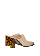 Beige mules with tortoiseshell block heels on a white background