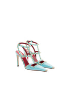 Pair of light blue high-heeled shoes with red interior and gold embellishments on a white background