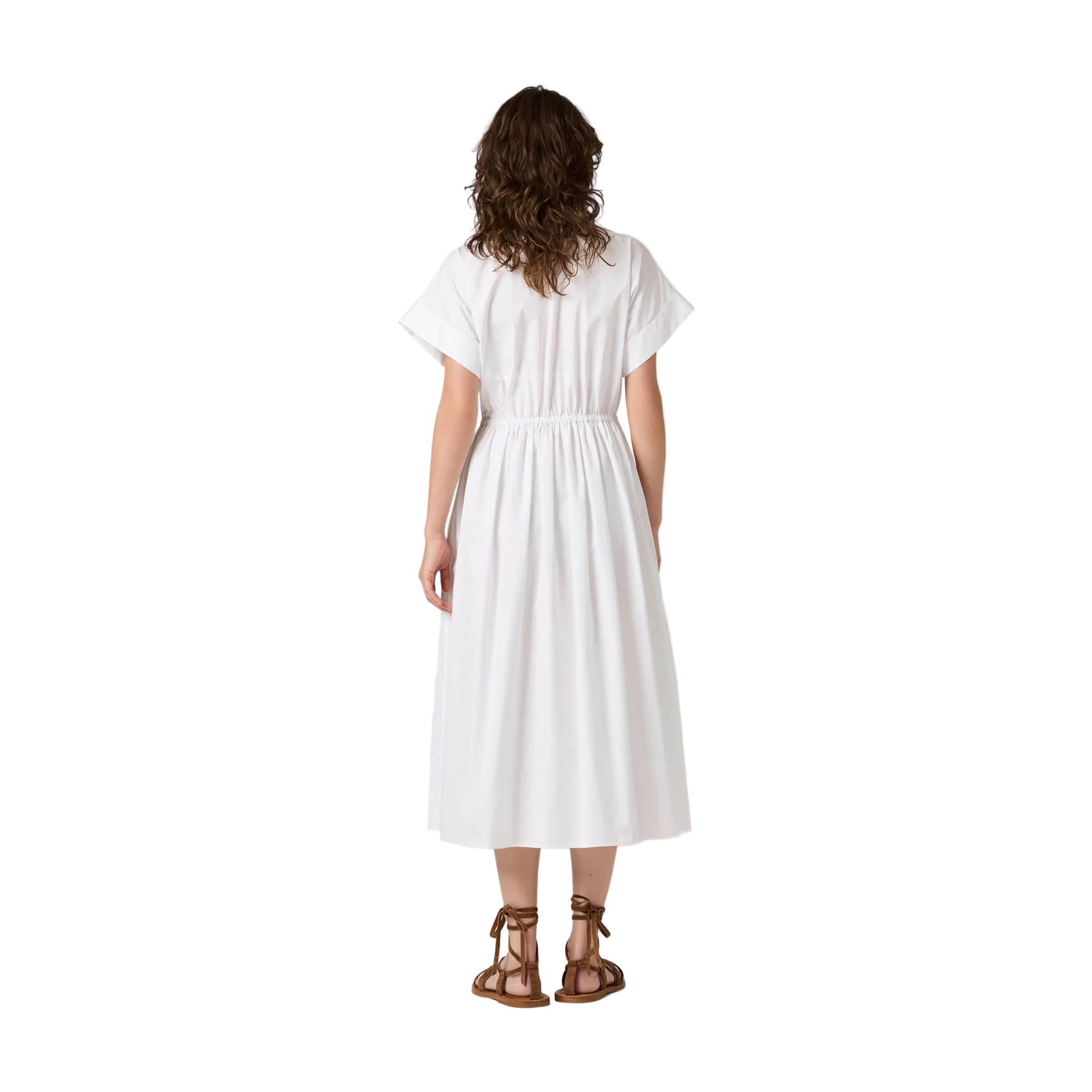 Woman wearing a white dress on a plain background