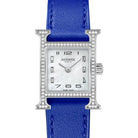 Hermes watch with blue strap on a light gray background