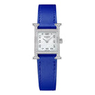 Hermes watch with blue strap on a light gray background