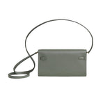 Gray handbag with a strap on a light gray background