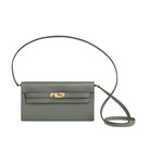 Green handbag with a strap on a light gray background