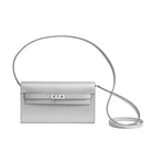 Silver handbag with a strap on a light gray background