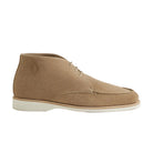 Beige suede shoe on a light gray background