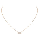 Delicate gold necklace with small diamonds on a white background