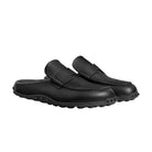 Pair of black loafers on a light beige background
