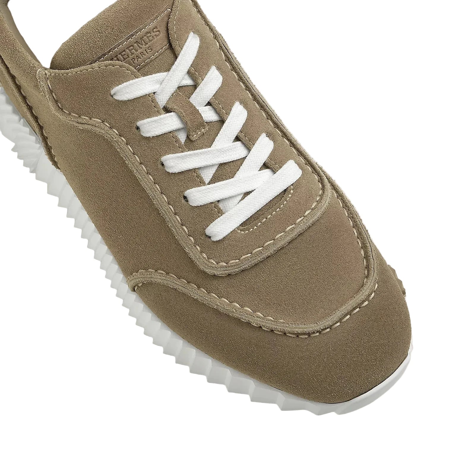 Brown sneaker with white laces on a light background