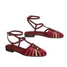 Red strappy sandals on a light gray background