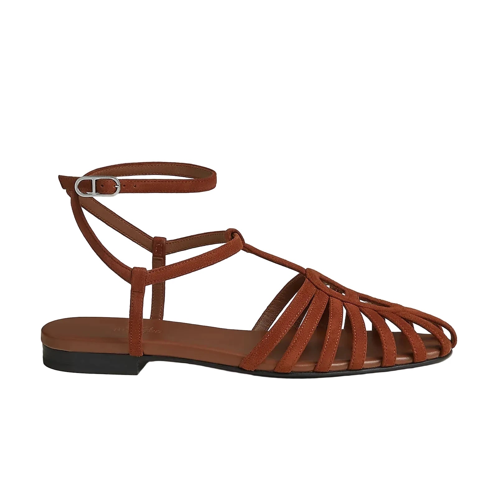 A single brown strappy flat sandal with an ankle strap and a low black heel, shown from the side on a light beige background.