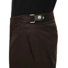 Brown pants with a belt on a beige background