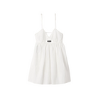 White dress with thin straps on a beige background