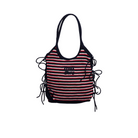 Striped handbag with black, red, and white pattern on a beige background