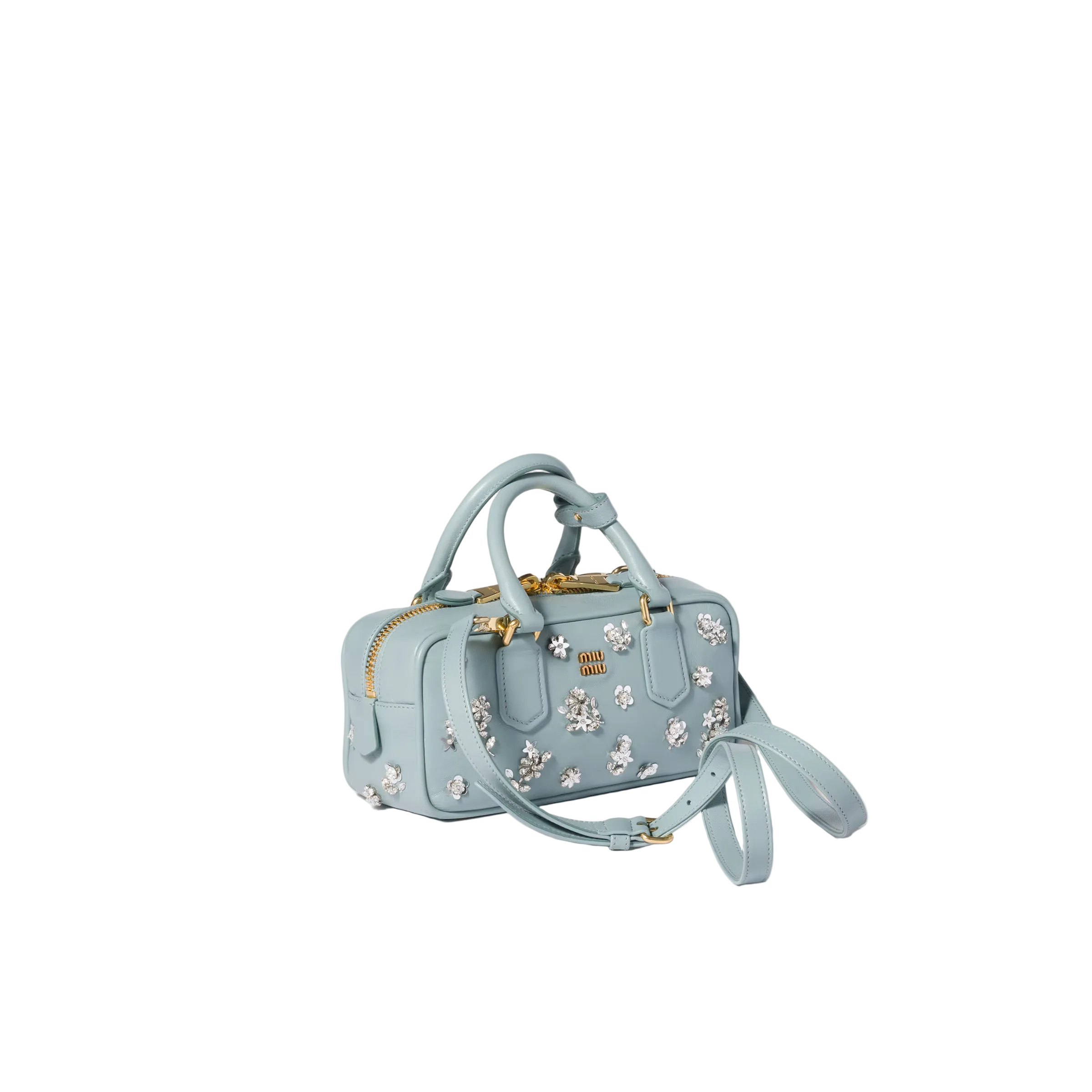 A light blue leather handbag with white floral embroidery, gold-tone hardware, top handles, and a detachable shoulder strap, photographed on a clean off-white background.